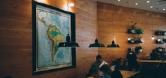 Students working at a table in front of a map