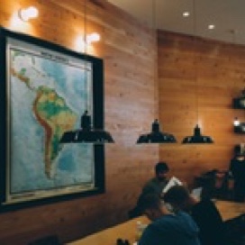 Students working at a table in front of a map